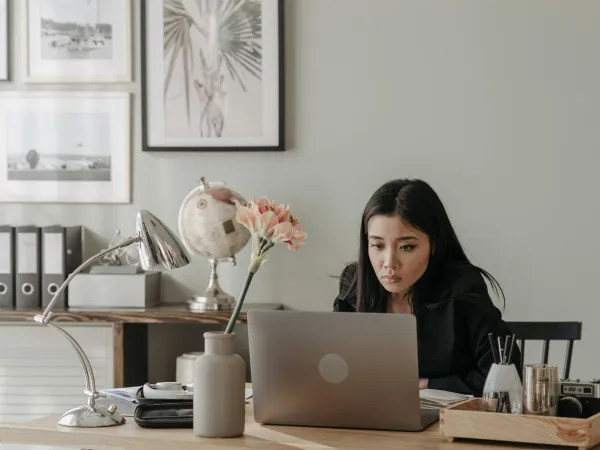 Woman sitting at desk working on laptop